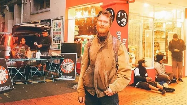 A redhead man standing in front of food truck