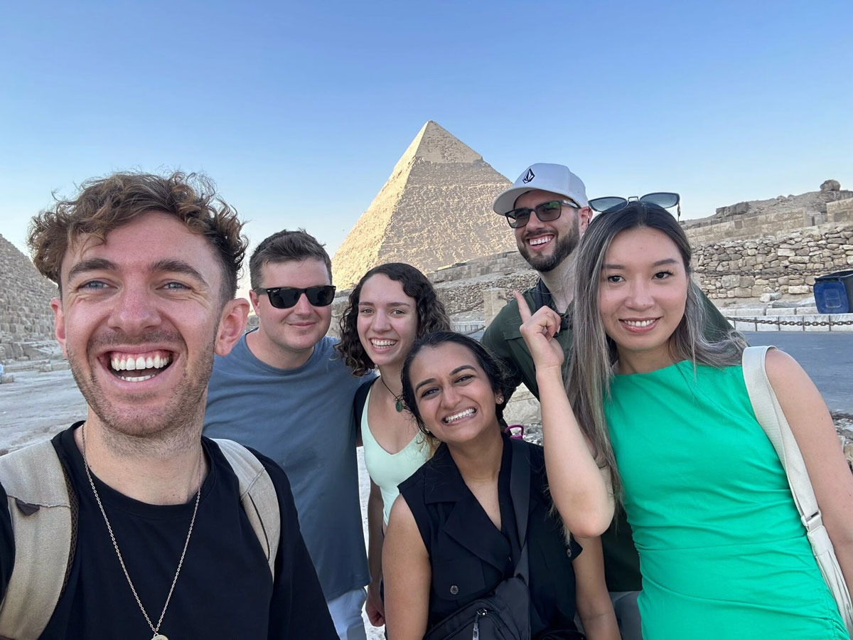 Friends taking a selfie Egyptian pyramid as background 