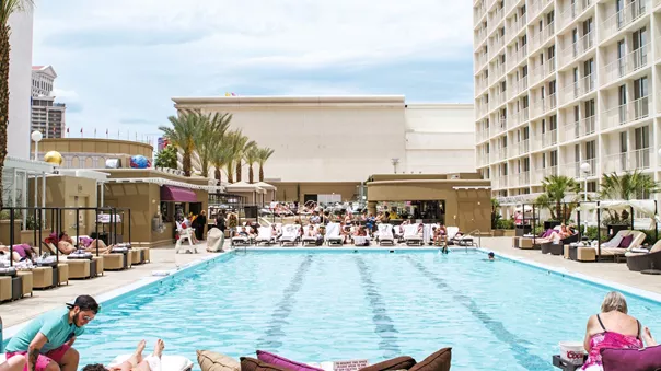 Hotel Overlooking Swimming Pool People Sunbathing
