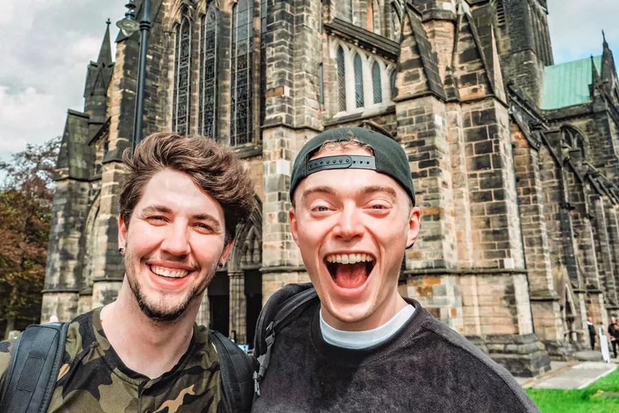 Friends Smiling Landmark Building At The Back