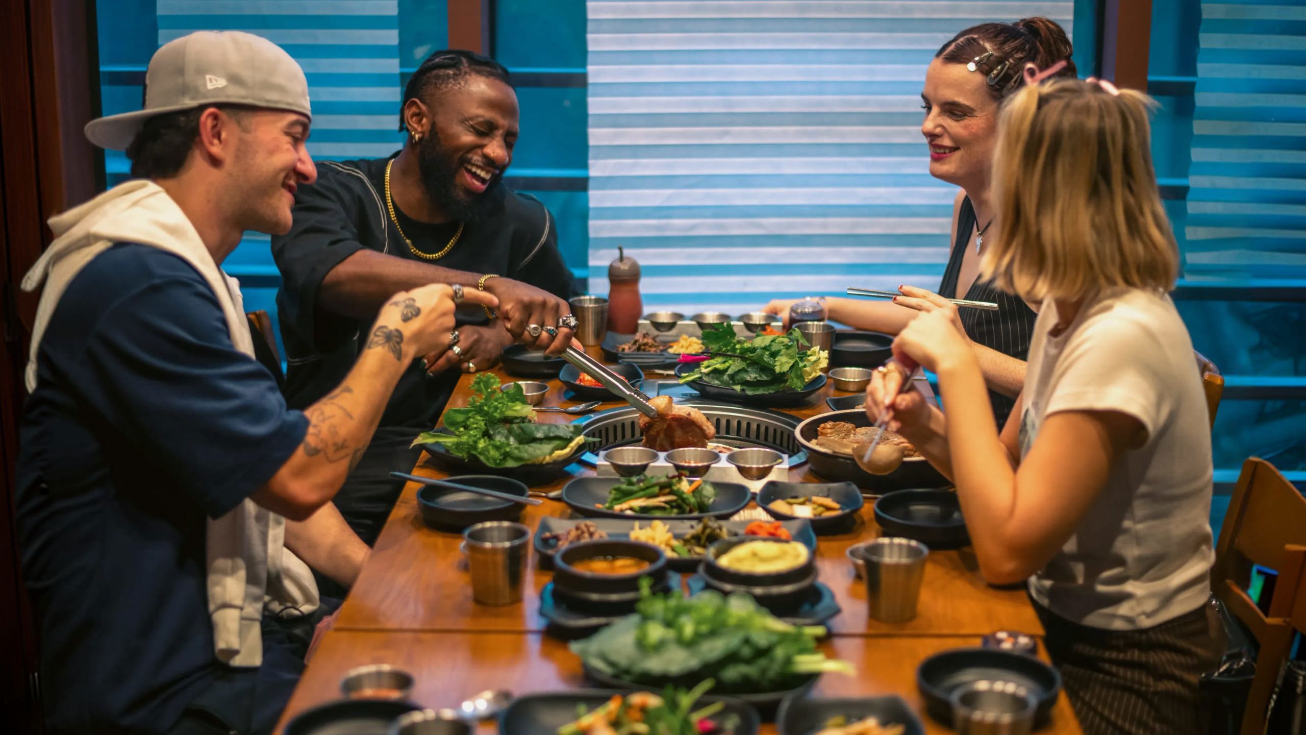Contiki group enjoying Korean barbecue at a restaurant in Seoul, South Korea - Contiki's Best of South Korea Tour