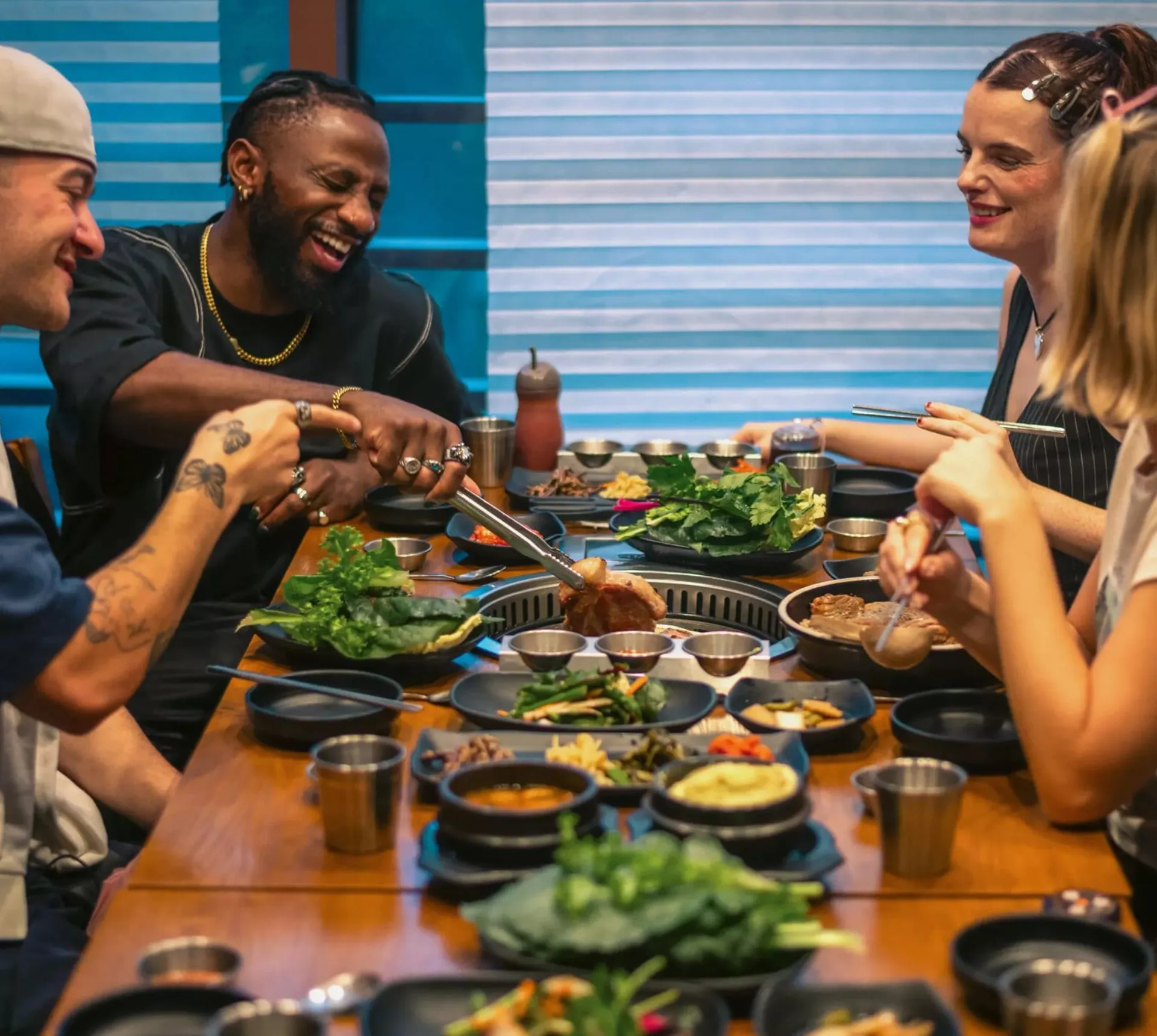 Contiki group enjoying Korean barbecue at a restaurant in Seoul, South Korea - Contiki's Best of South Korea Tour