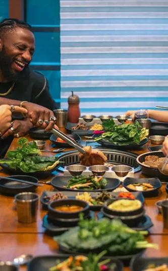 Contiki group enjoying Korean barbecue at a restaurant in Seoul, South Korea - Contiki's Best of South Korea Tour