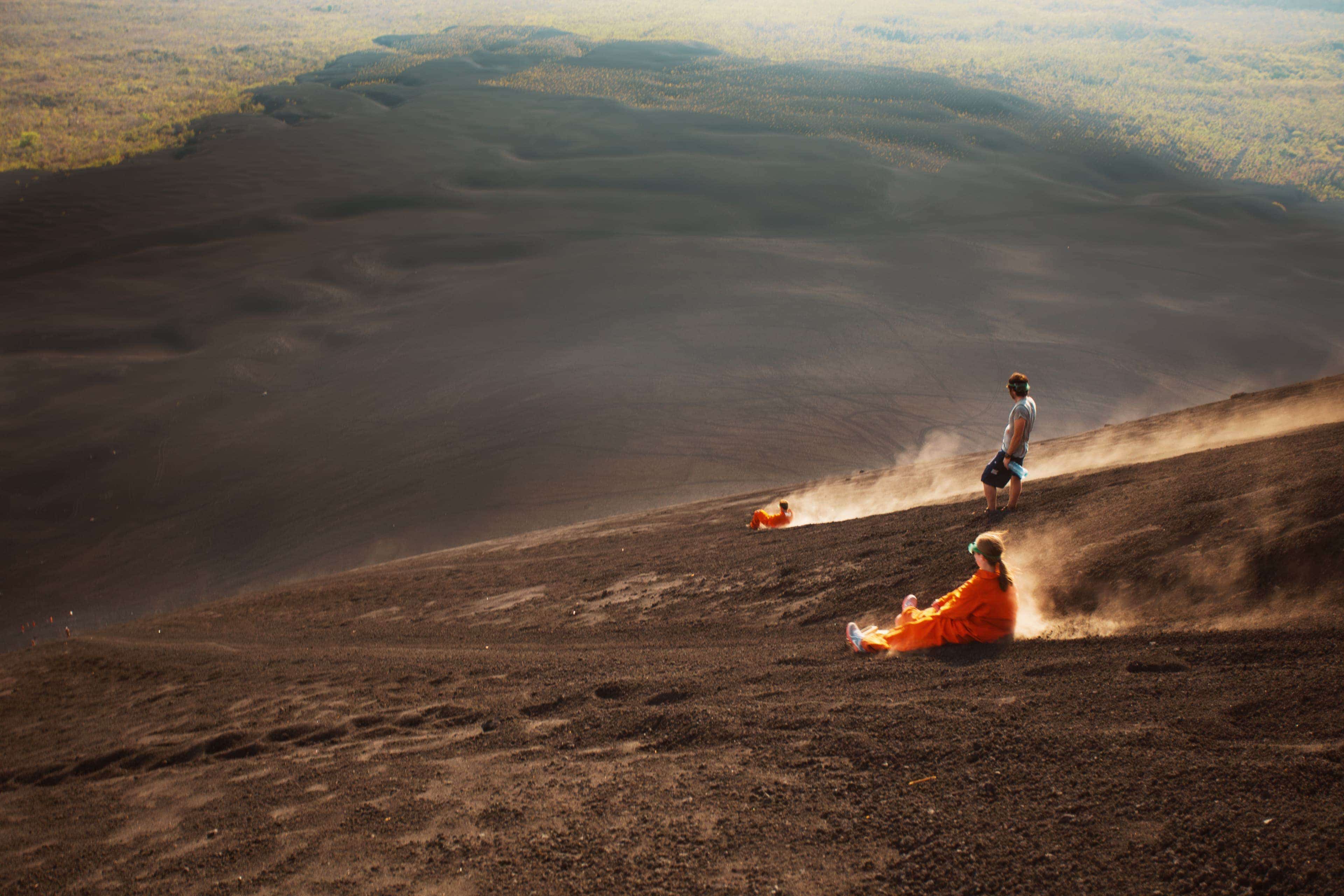 region-latinamerica-whyvisit-travellers-volcano-boarding-down-black-sand-slopes-of-cerro-negro.jpg