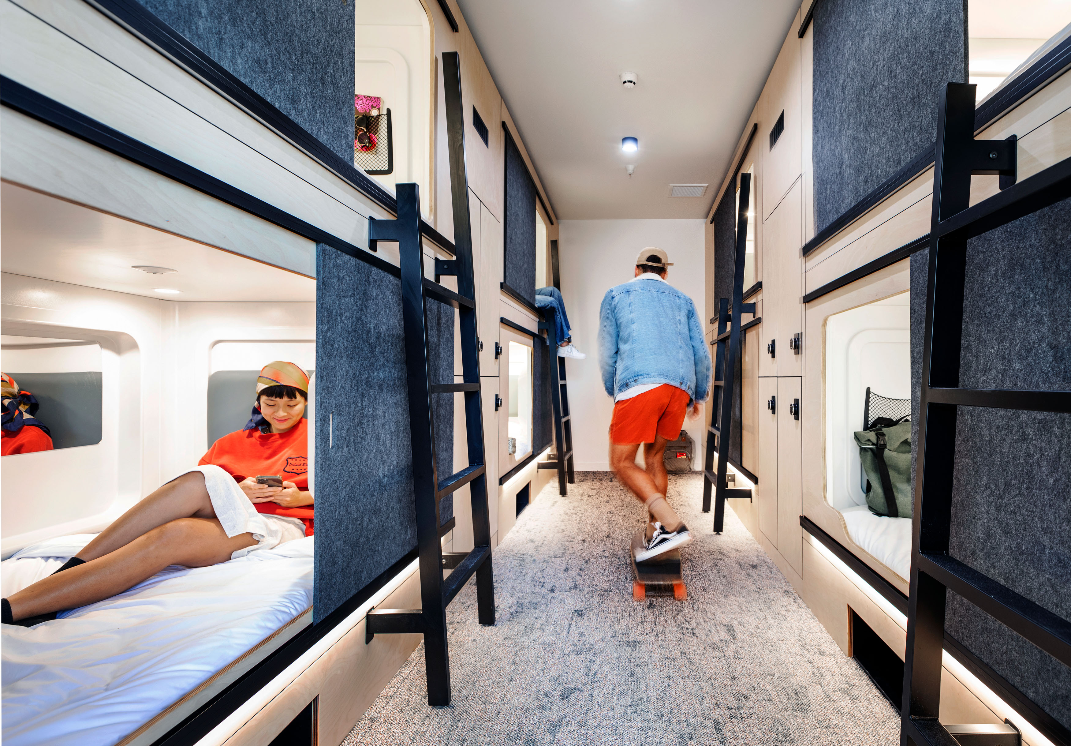 Young People In Hostel Skateboarding And Reading