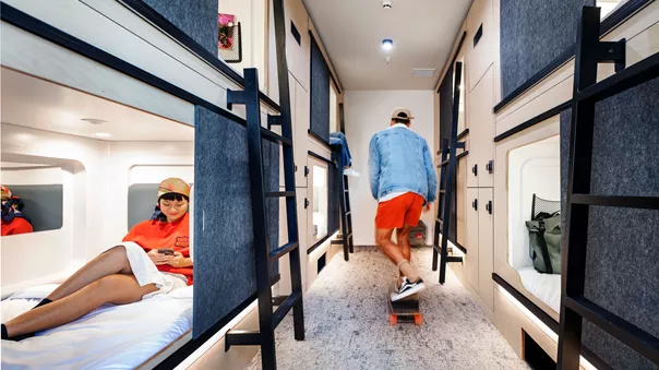 Young People In Hostel Skateboarding And Reading