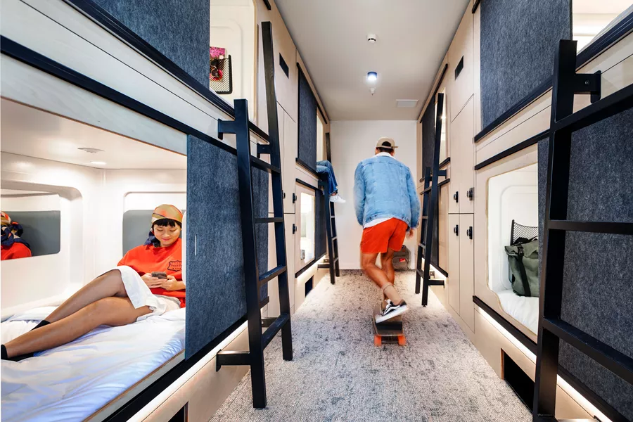 Young People In Hostel Skateboarding And Reading