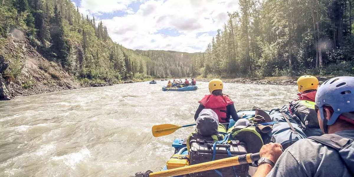 People Enjoying A Rafting Adventure