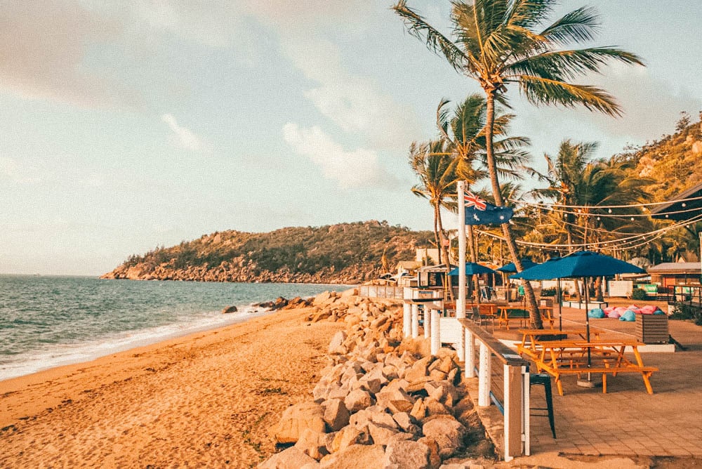 Sunny coast and a beach with umbrellas and a restaurant