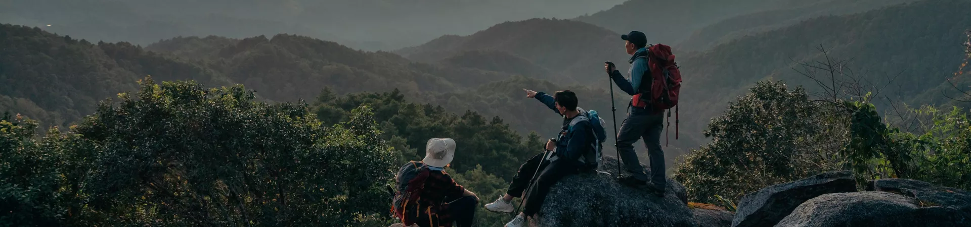 Three People Hiking And Observing The Sunset Clear Sky