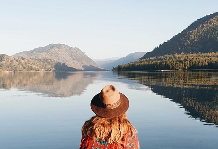 Girl in the mountains, lake and trees view