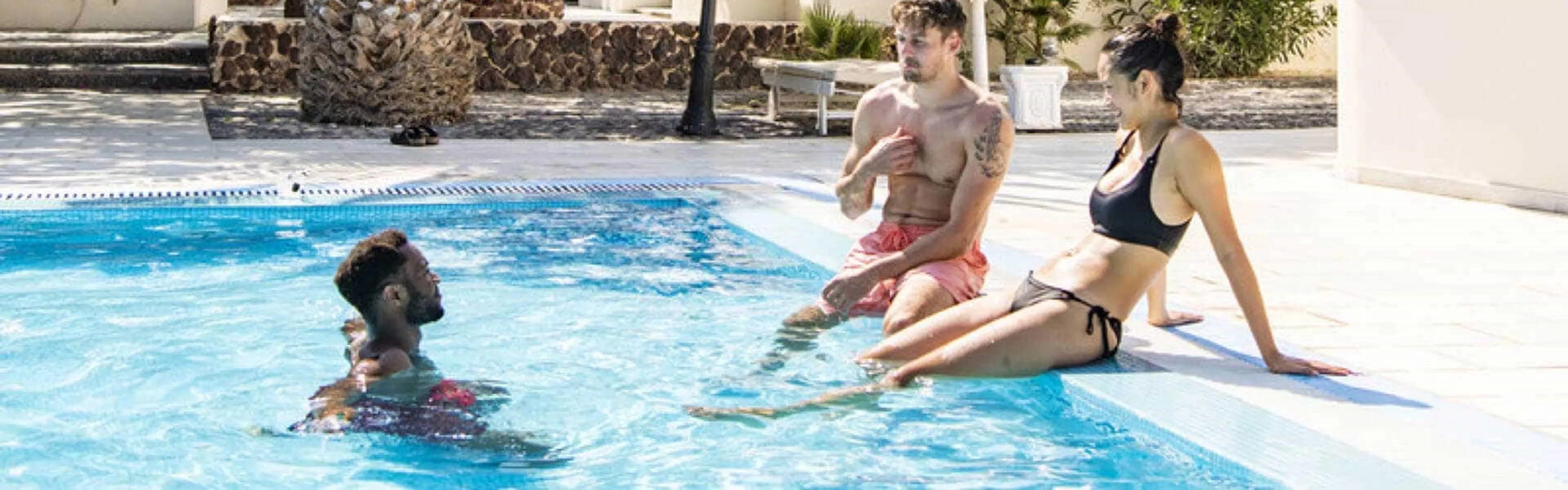 Guests of Okeanis Beach Hotel relaxing in swimming pool