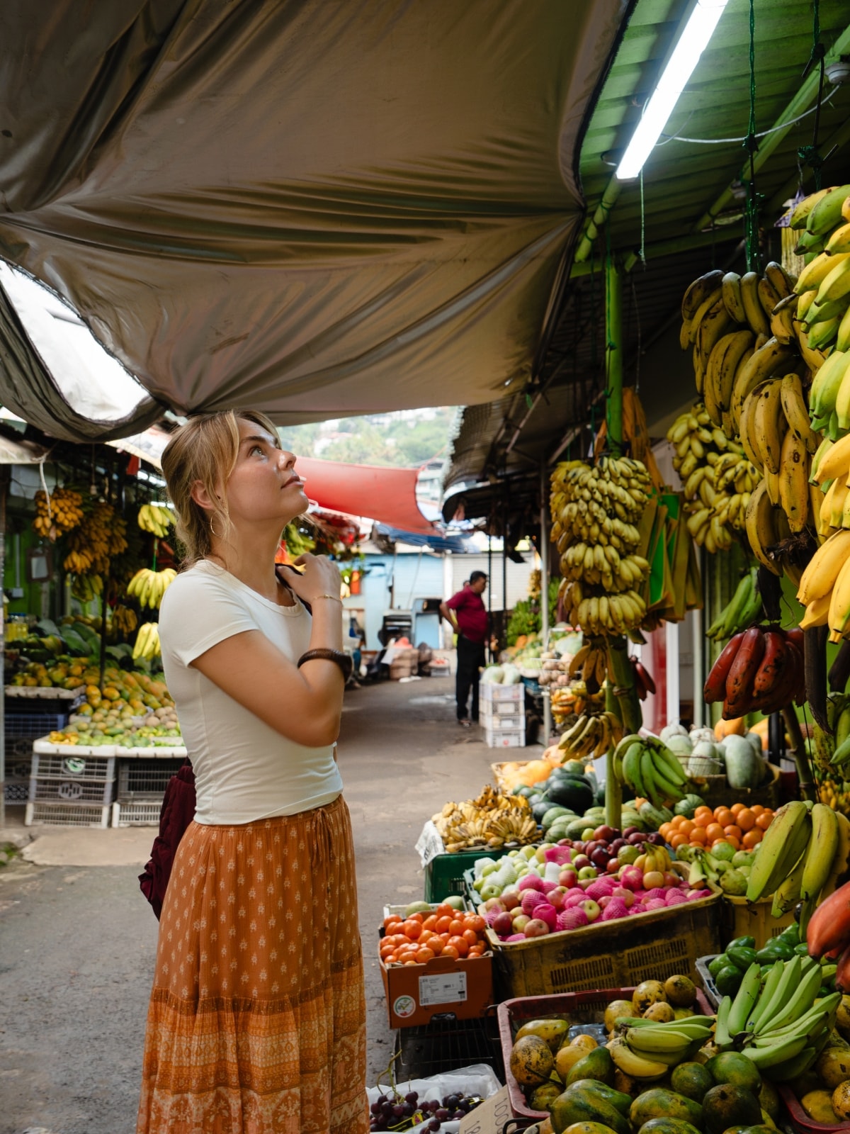 Traveller exploring a local fruit and vegetable market in Sri Lanka.