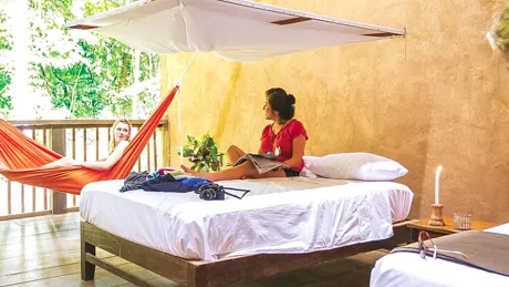 two-women-talking-one-on-the-bed-one-in-a-hammock.jpg