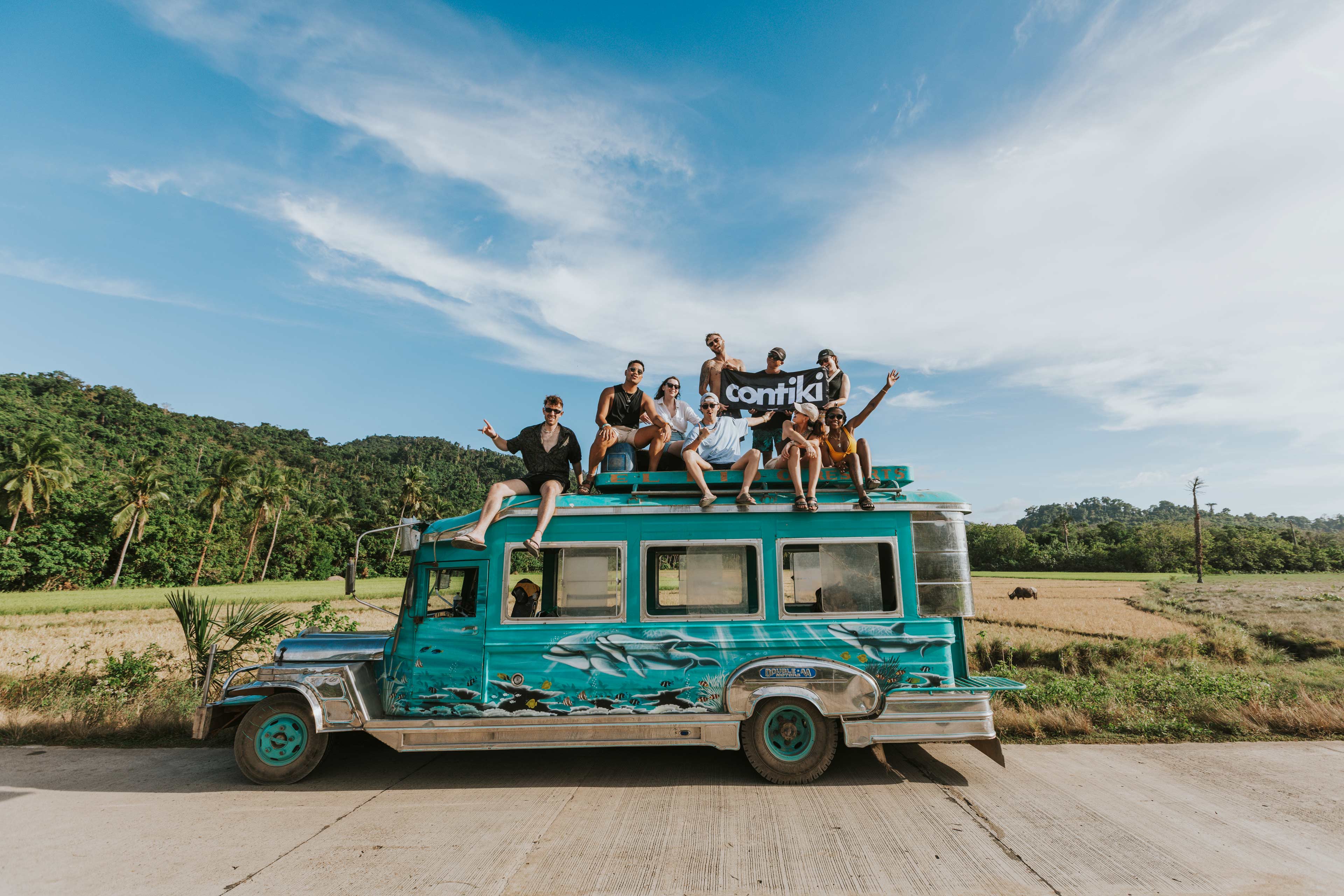 Group Sat On The Top Of A Jeepney