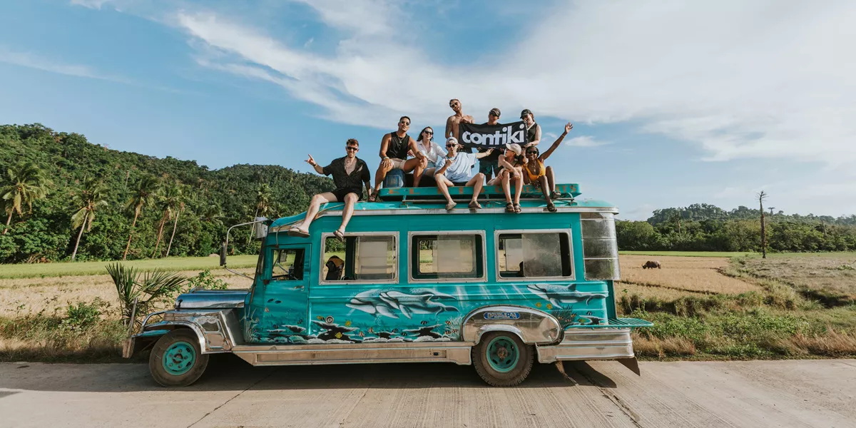 Group Sat On The Top Of A Jeepney