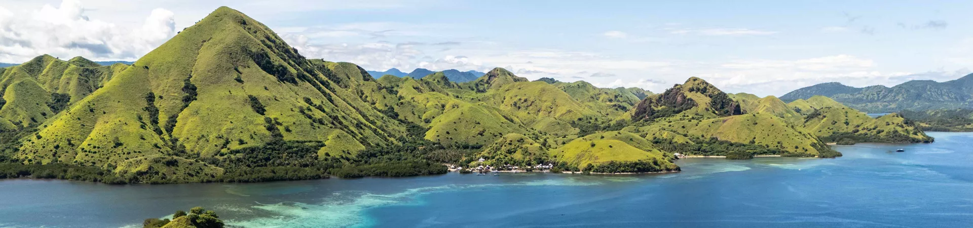 boats blue sea water green mountains