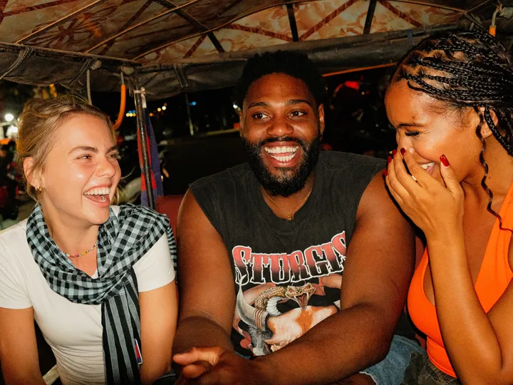 loyalty-card-travellers-laughing-back-of-tuktuk-night-siem-reap-cambodia.jpg