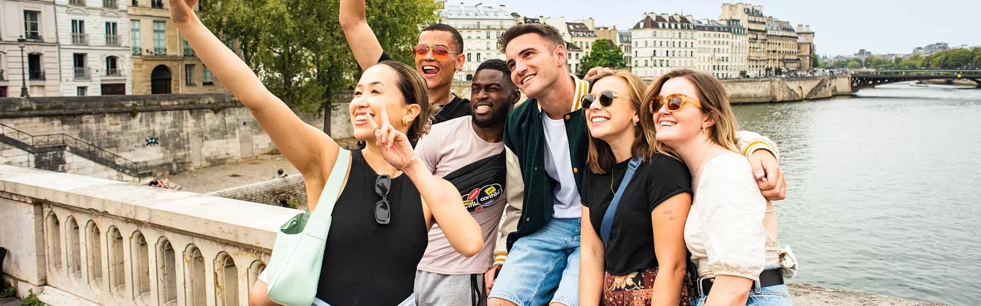 Group Taking Selfie On Bridge In Paris France