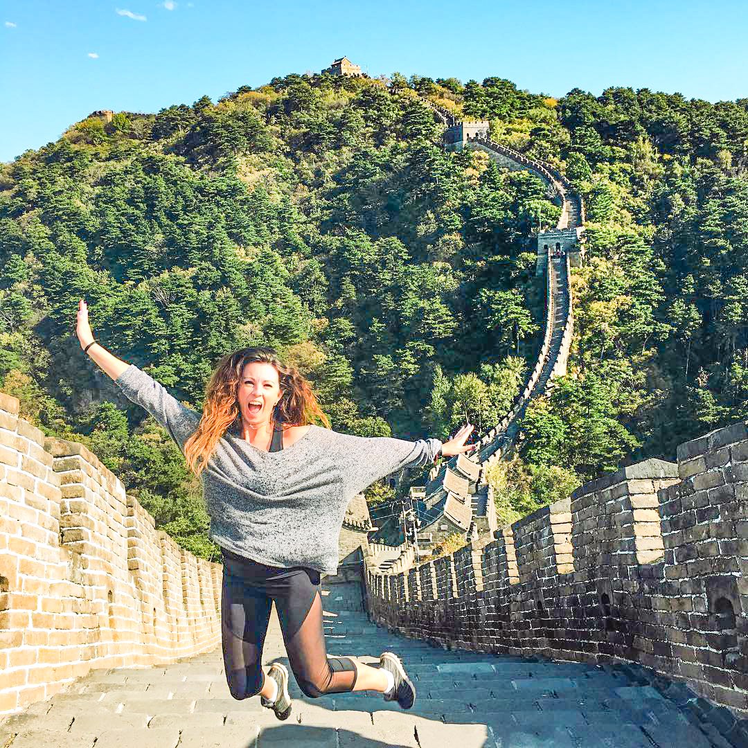 Traveller jumping on the Great Wall of China in Beijing, China