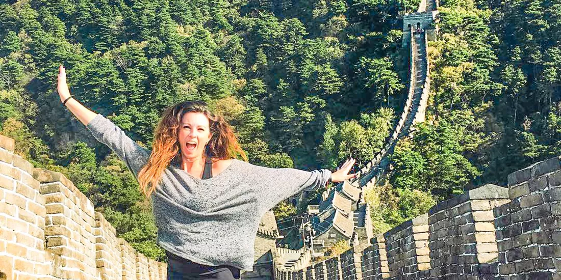 Traveller jumping on the Great Wall of China in Beijing, China