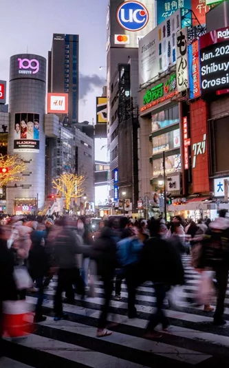 Shibuya Crossing illuminated at night in Tokyo, Japan, on Contiki's Japan in a Week 35 to 45 Tour