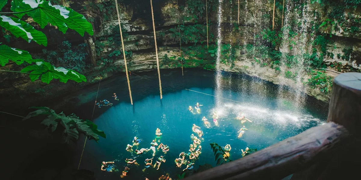 People Swimming In Cave Clear Blue Water