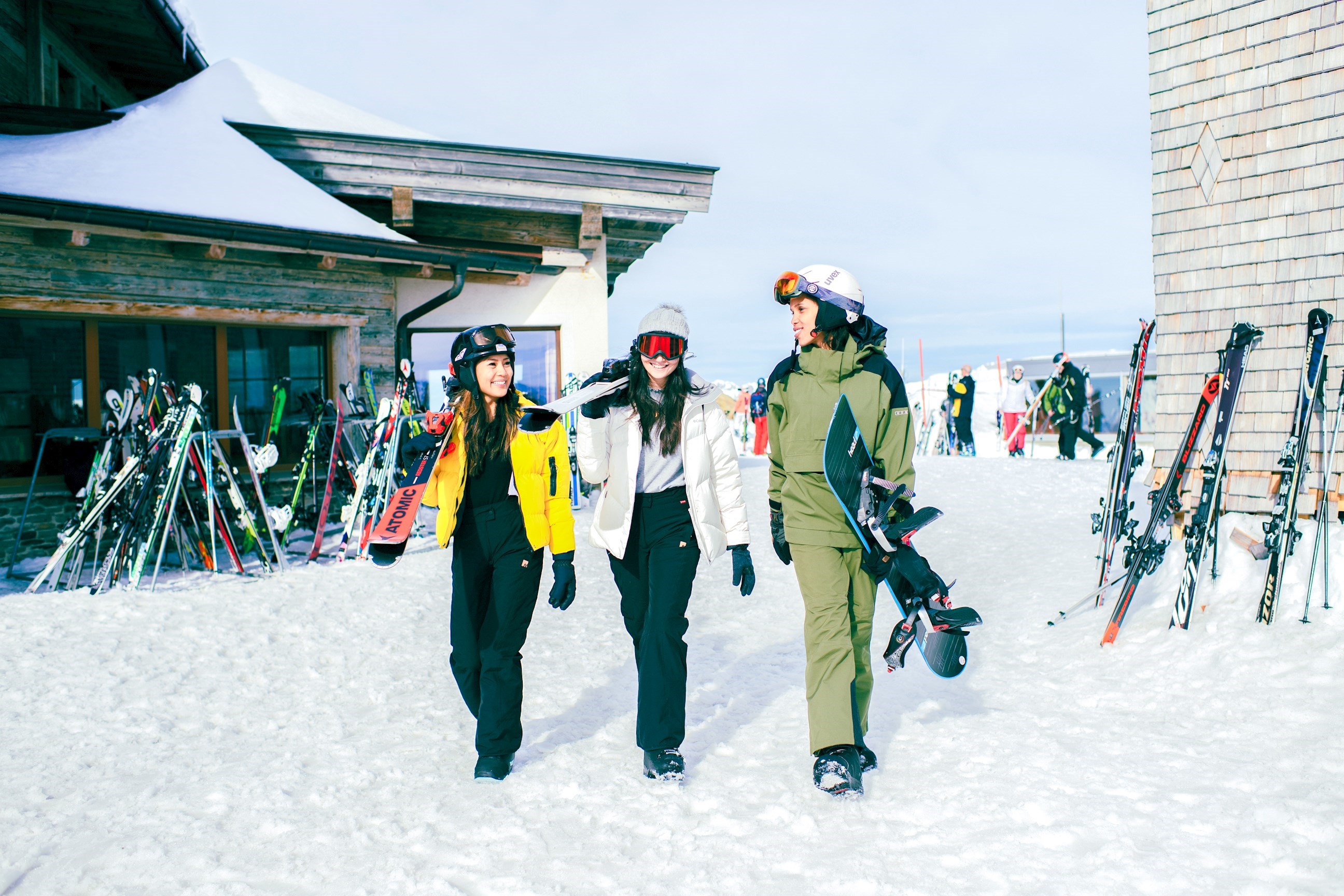 Group of Travellers walking in the snow carrying skis in Hopfgarten, Austria