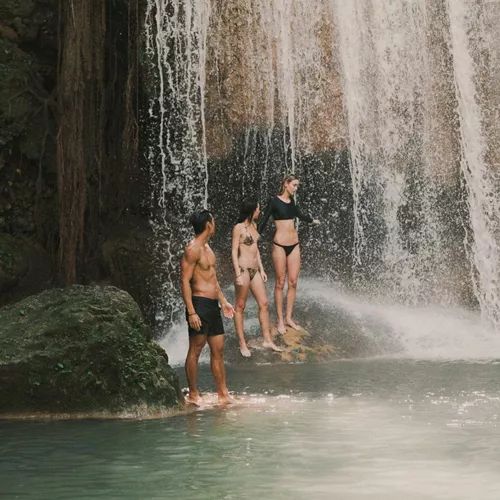 Travellers swimming beneath a tropical waterfall in Northern Thailand - Contiki Chiang Mai & Pai Tour
