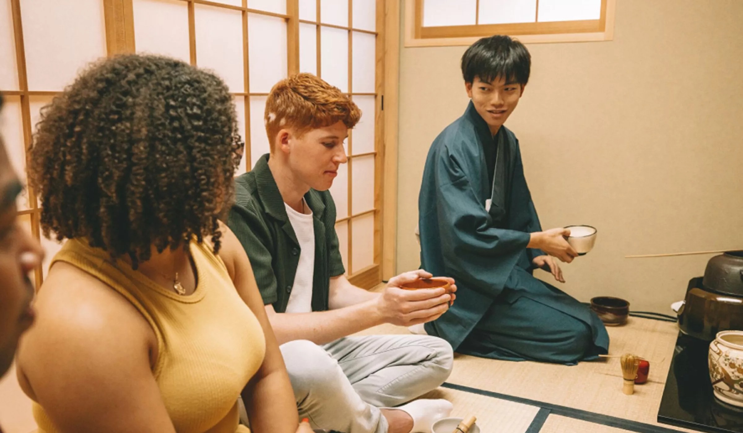A group of people having traditional Japanese tea.
