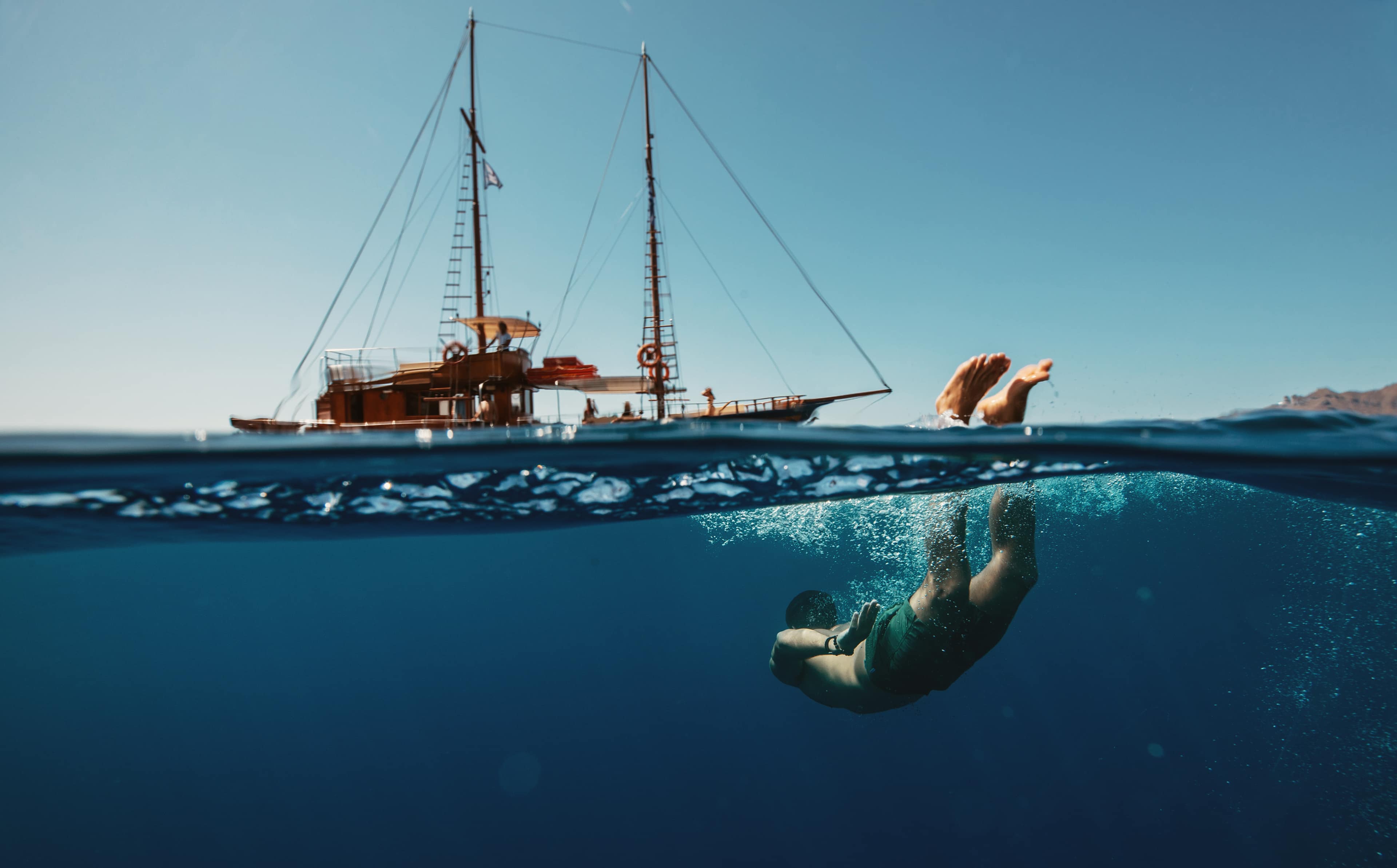 Islandhopping Banner Traveller Diving Below Ocean Island Hopping Greece Sail