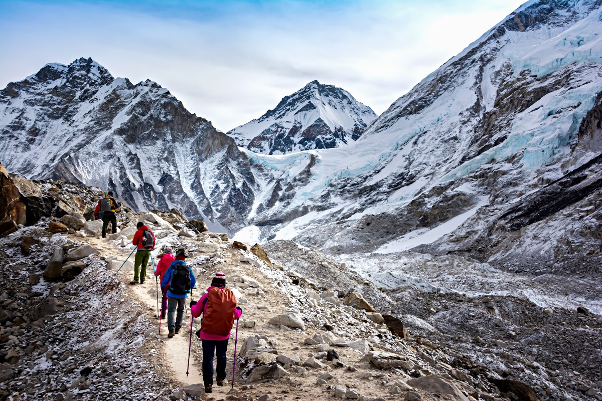 A group of people hiking in snowy mountains in Nepal.