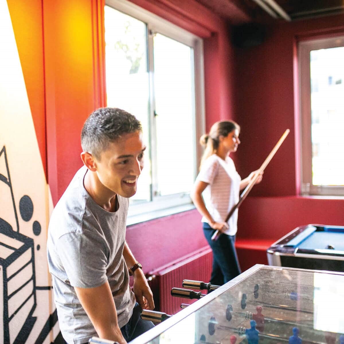 Smiling man playing snooker