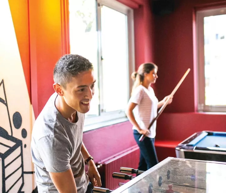 Smiling man playing snooker
