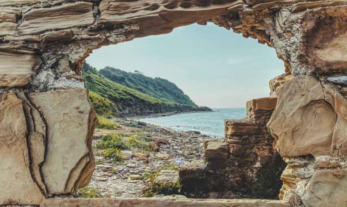 Albanian Mountains And Sea Shot Thrpough Hole In Rock