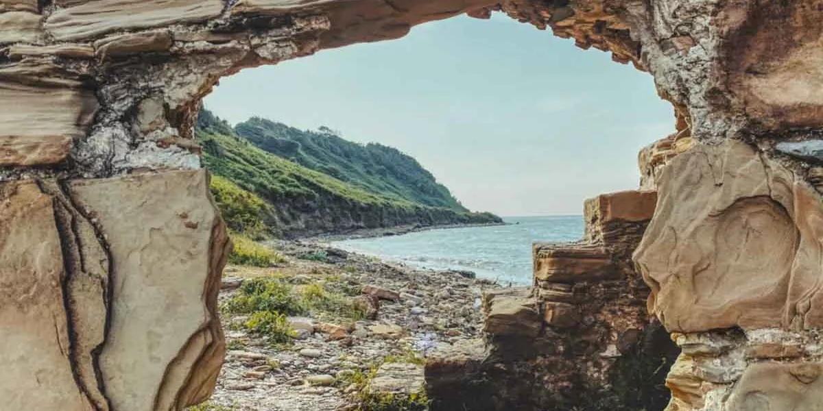 Albanian Mountains And Sea Shot Thrpough Hole In Rock