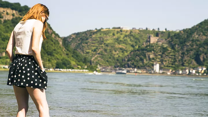 Traveller standing on the River Rhine in the Rhine Valley, Germany