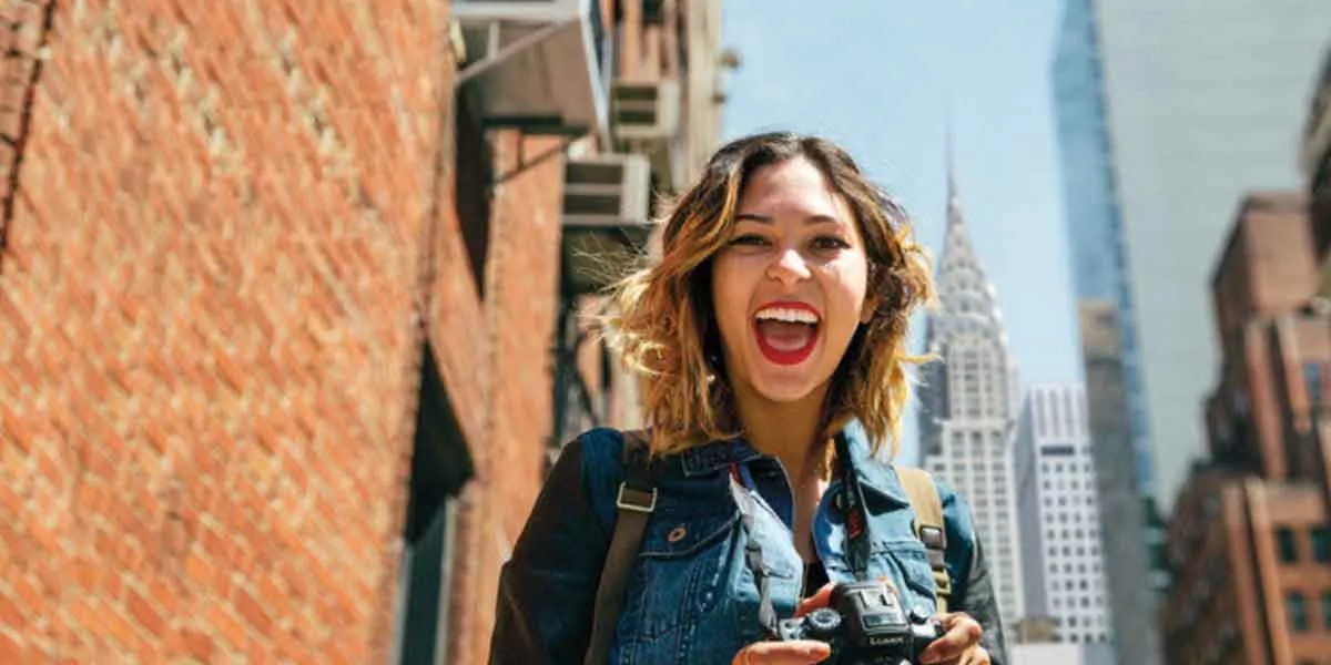 Young Woman Smiling While Holding Camera