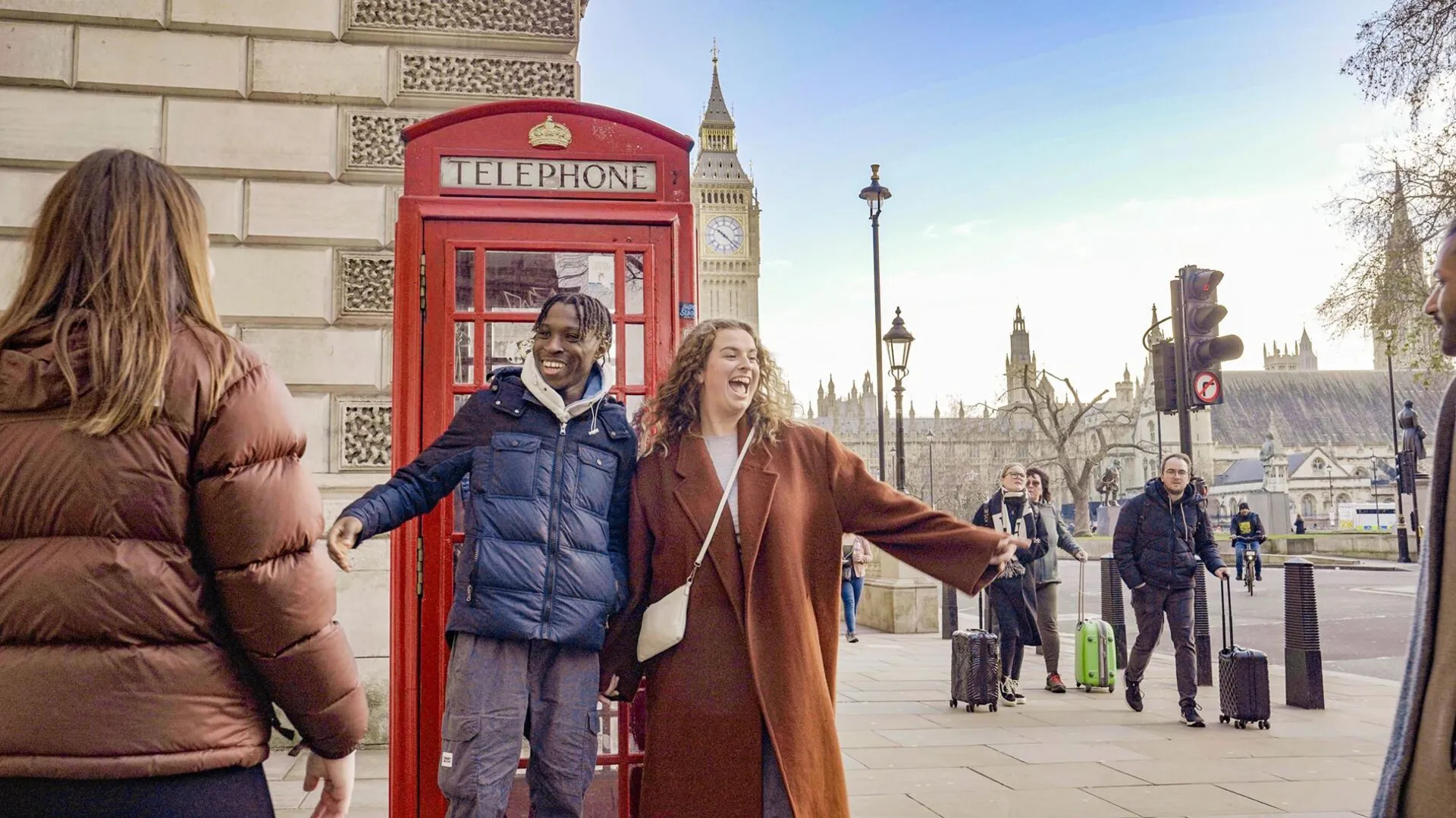Friends Taking A Picture Close To A Phone Box Big Ben As Background in England.