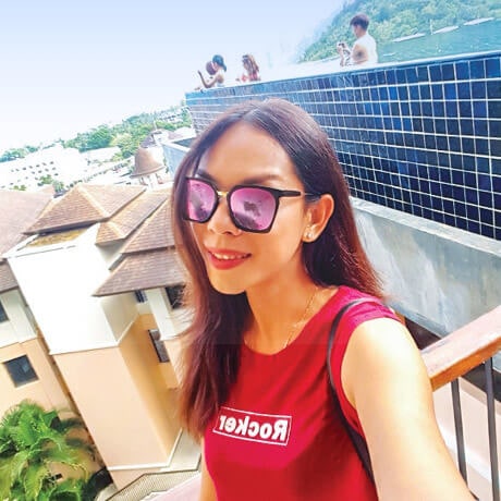 A girl taking selfie with city buildings in background