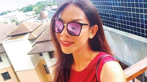 A girl taking selfie with city buildings in background