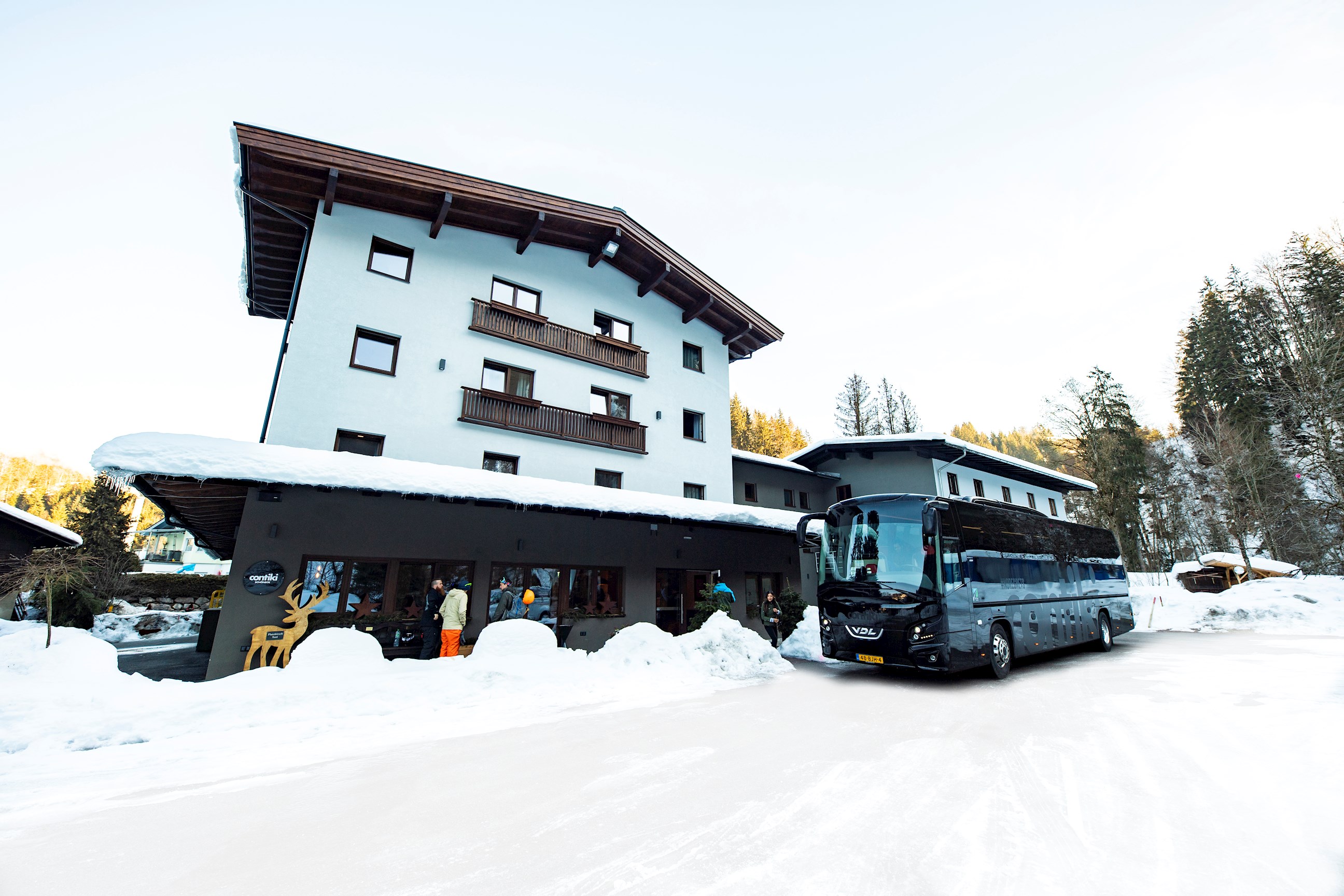 Travellers laughing in the snow in the town of Hopfgarten, Austria