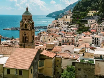 View over Amalfi, Italy, with the Cathedral of St. Andrew, colourful hillside buildings and the Tyrrhenian Sea.