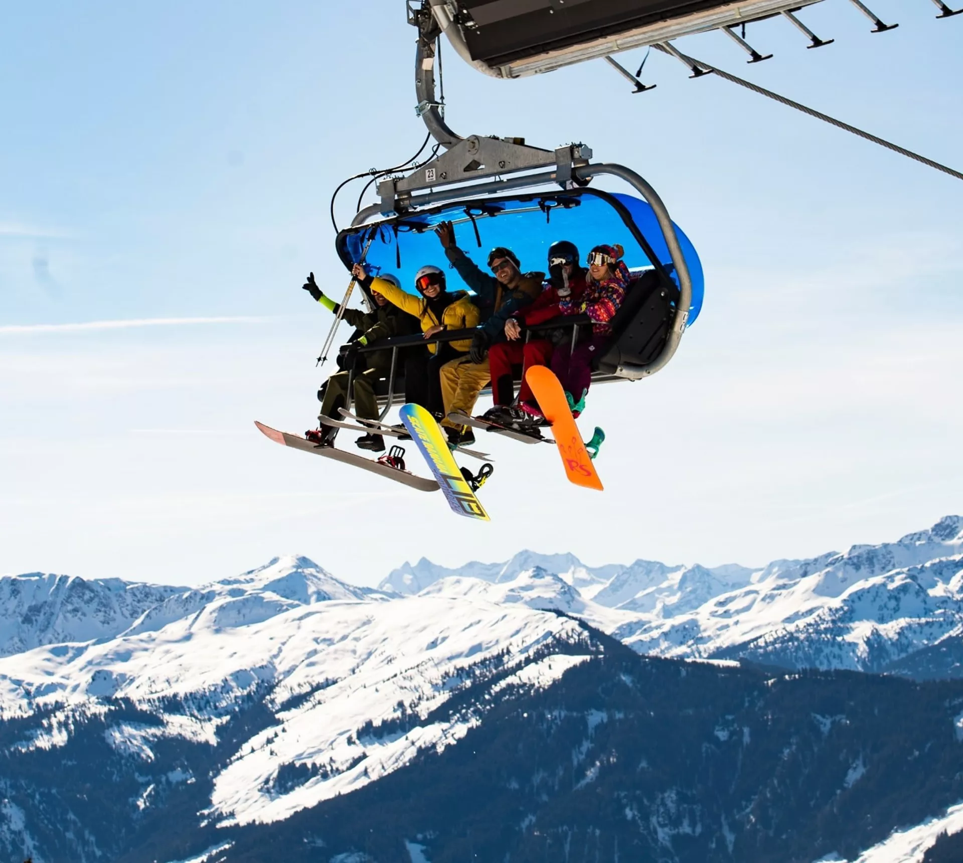 Travellers riding a chairlift with panoramic views of the Austrian Alps on the Contiki Ski Austria 35 to 45 Tour