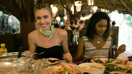 two-young-women-enjoying-a-meal.webp