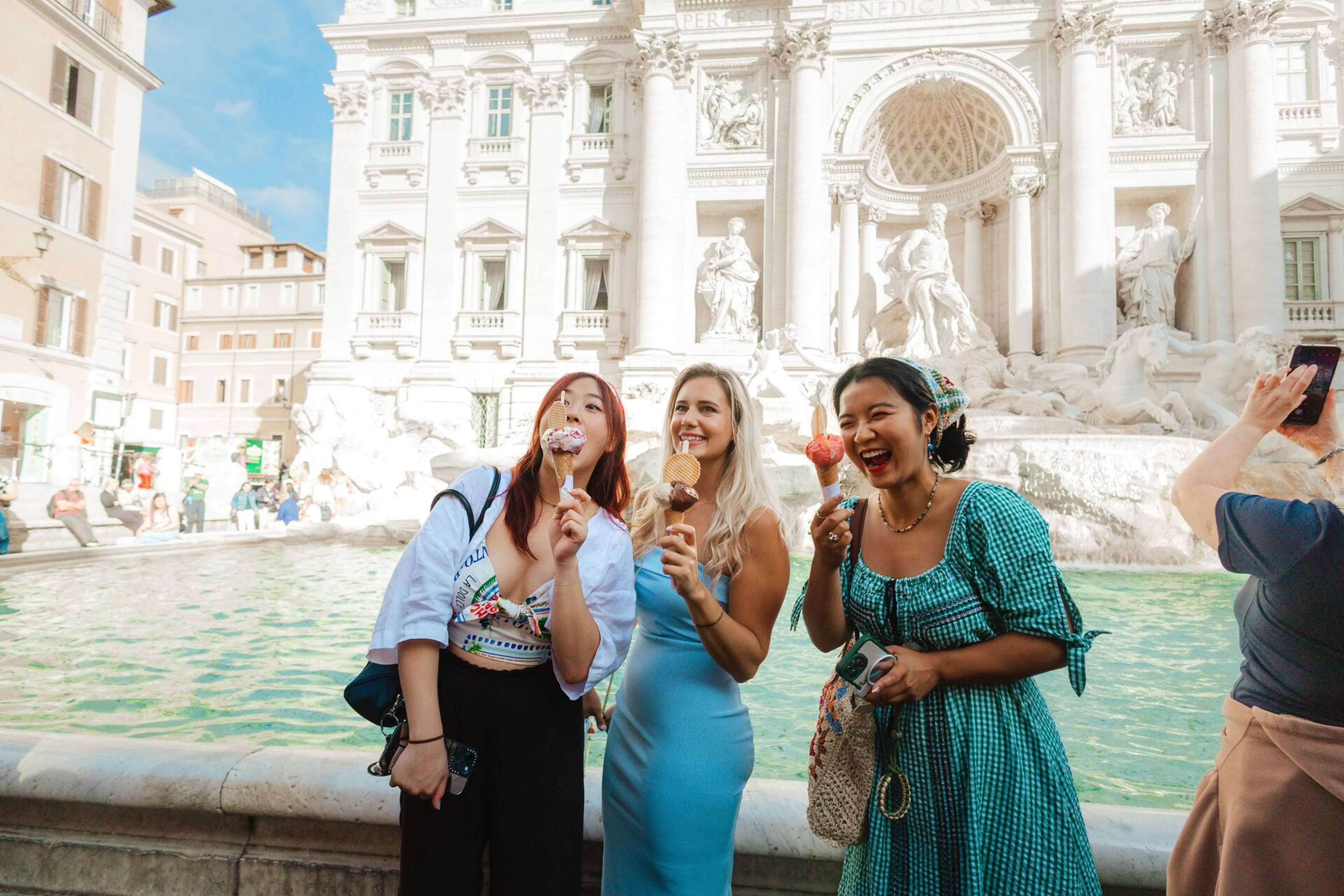 Three Friends Smiling and Eating Ice cream on Sunny Day