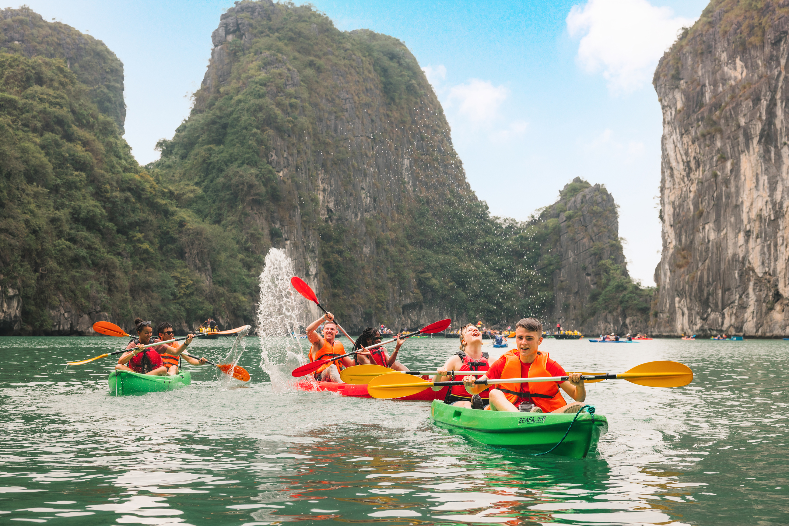 Travellers kayaking on Halong Bay, Vietnam