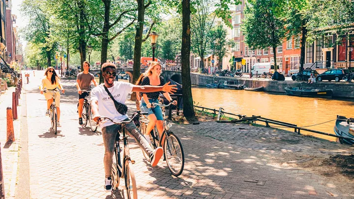 Cycling past Canals in Amsterdam, Netherlands
