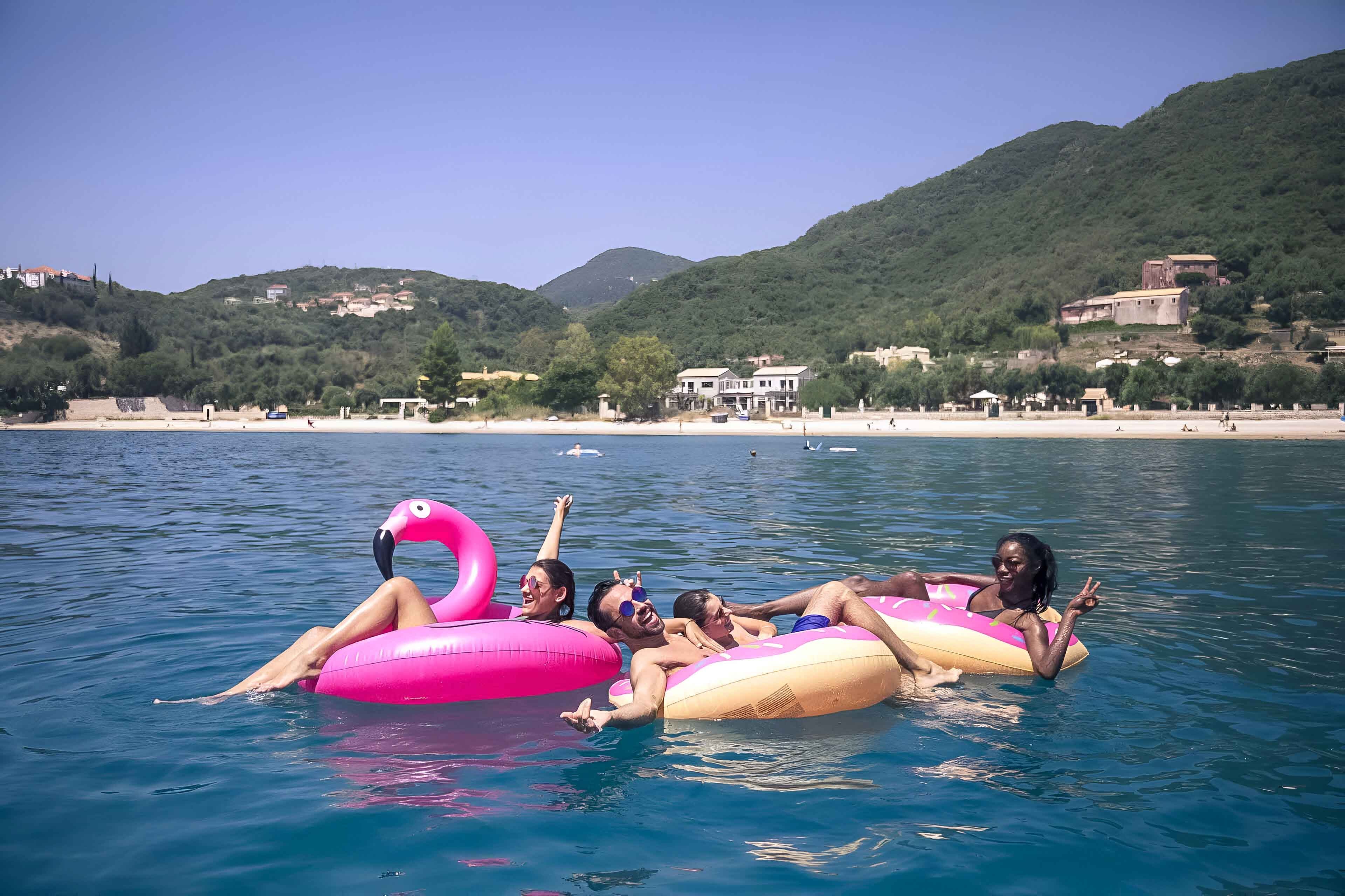 Young group of friends in the sea in Croatia.