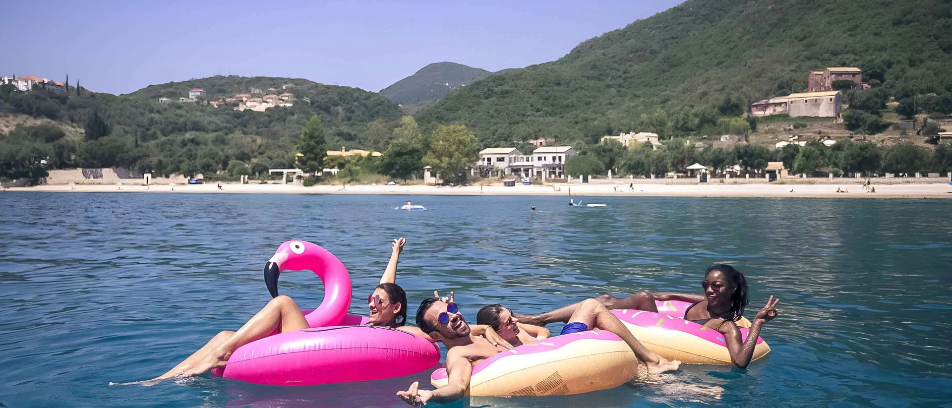 Young group of friends in the sea in Croatia.